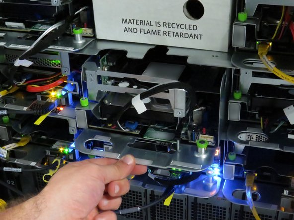 Continue pushing the server until the server chassis pin secures the server.