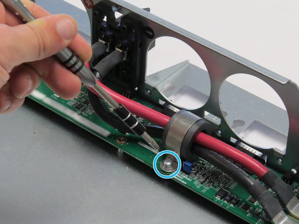 Unscrew one Phillips #2 screw securing the bus lead management clip to the fan controller board.