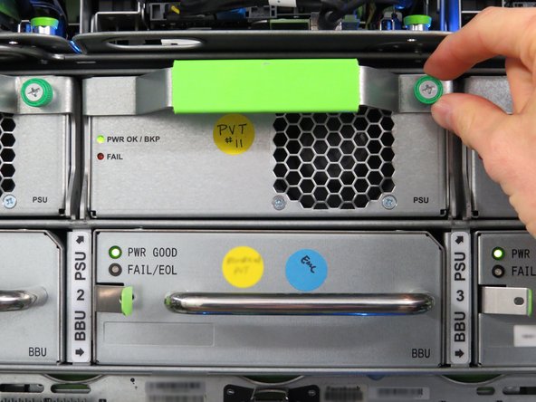 Identify the location of the degraded PSU and loosen the green thumbscrew.