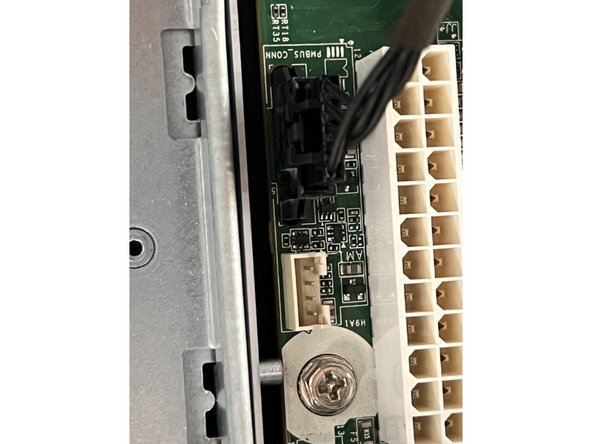 Remove the smaller black connector.  It too has a small locking clasp.  Depress the clasp and pull the connector housing straight up.