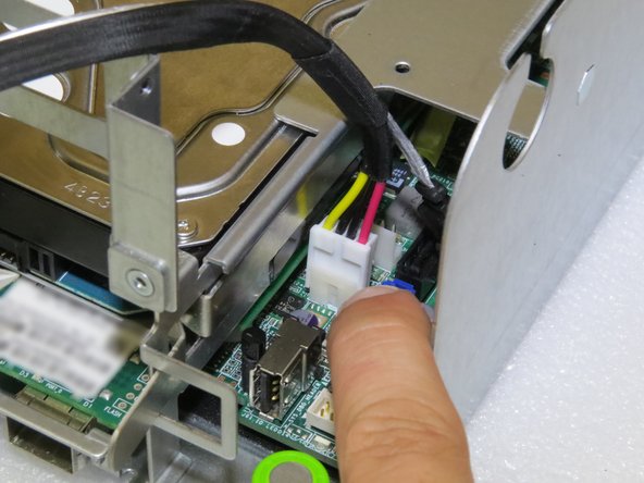 Lightly push the nylon power connector about 1.0cm towards the rear of the server.