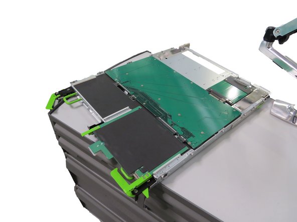 Place the tray upside down on a work bench so that the tray circuit boards are exposed, as shown.
