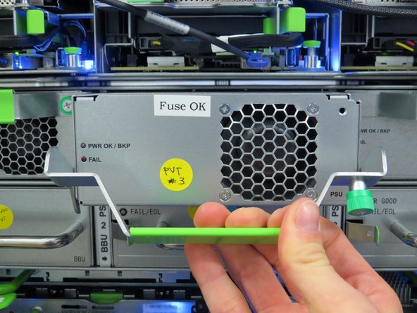 Pull the handle downward to release the PSU from the power shelf socket.