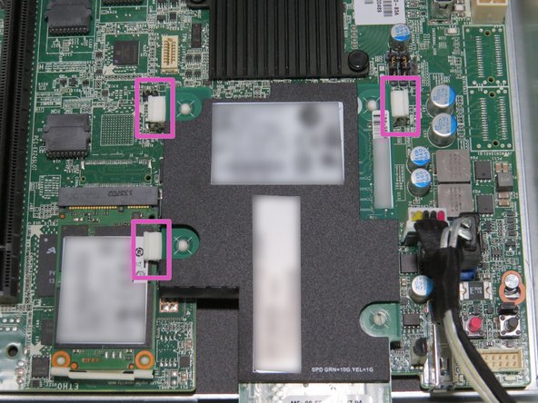 Press (3) retention tabs downwards, as shown.