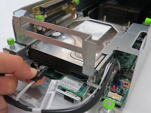 Press the metal retention tab to release the cable.