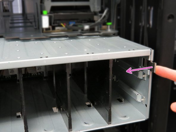 Continue sliding the shelf into the rack.