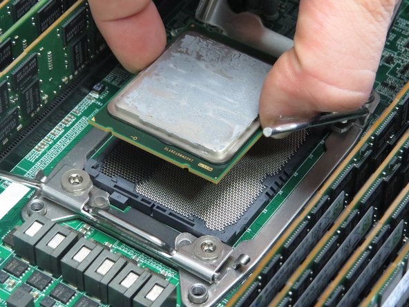 Take care not to touch the LGA socket pins as you lift the CPU.
