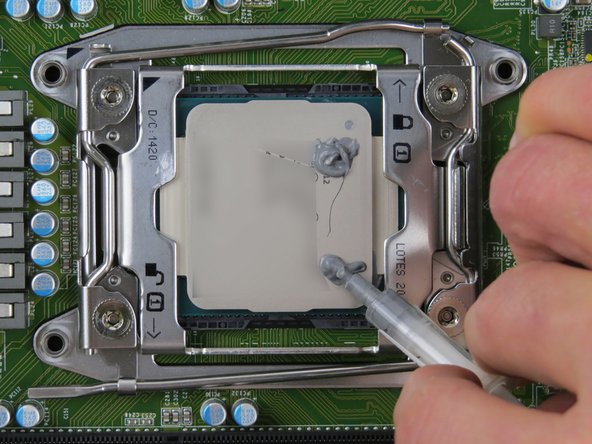 Place 0.2 grams of thermal compound on each CPU corner. Drag residue towards the center of the CPU.