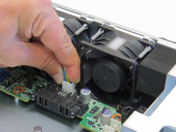 Disconnect the fan power cable from the middle plane board.
