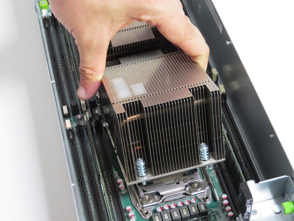 Pivot the heatsink forward so that the front two screw posts mate with the CPU retention post holes, as shown.