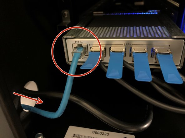 Connect your network cable to the network switch, routing the cable through the adjacent hole in the unit