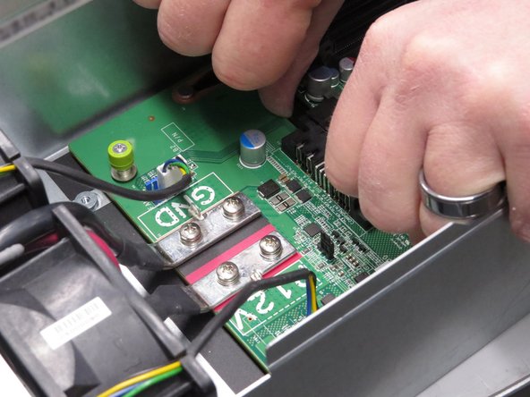 Push the middle plane board towards the rear of the server.