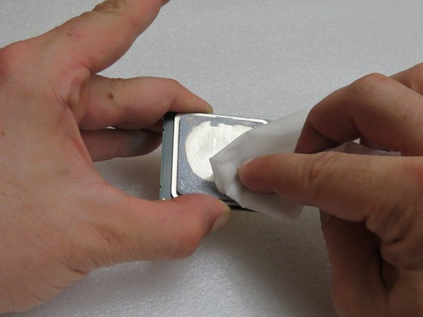 Hold the CPU by its edges.