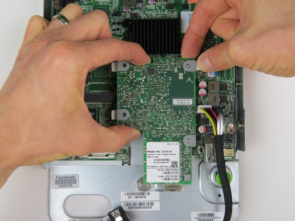 Lift the NIC to remove it from the motherboard.