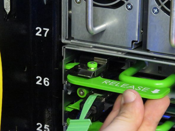 Only one storage tray retention lever is shown. Make sure to lock both handles.