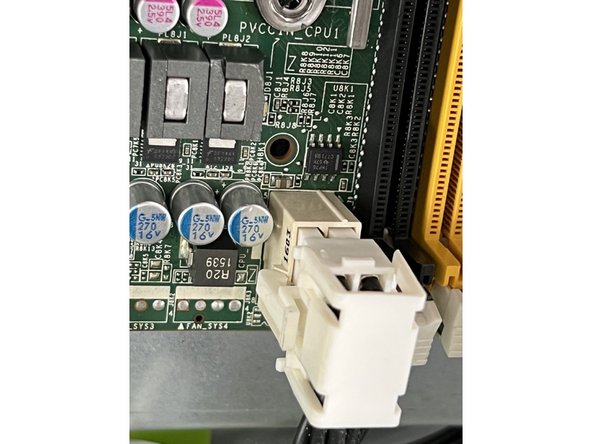Remove the two final connectors at the rear of the board by depressing the locking claps and pulling upwards