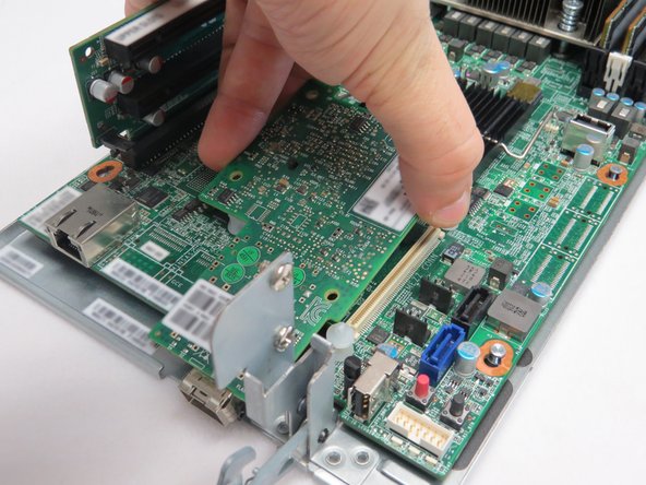 Lift the NIC away from the motherboard.