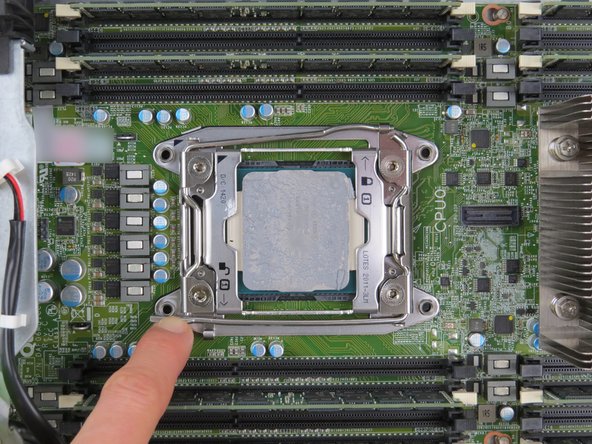 Unlatch the 'unlock' retention lock first, by simultaneously pushing down and inward on the lever as shown.