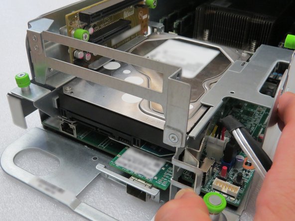 Press the hard disk drive retention bracket towards the right.