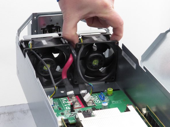 Grasp the fan as shown and lift it away from the server chassis.