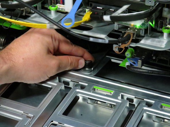 Loosen the thumbscrew.