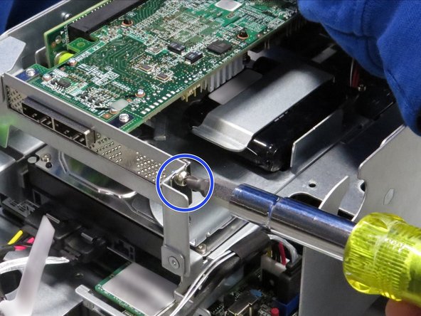 Unscrew the Phillips #2 screw from the RAID controller bracket.