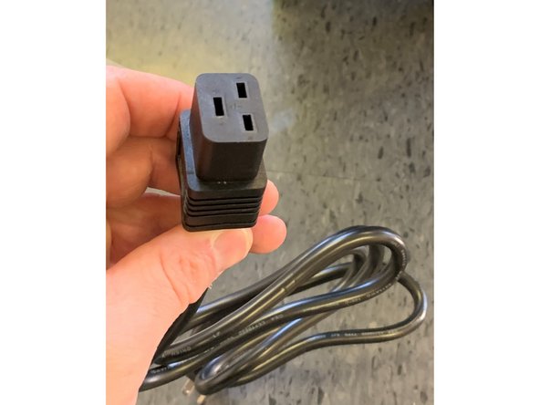 Insert the female end of the cable to the input receptacle of the power supply at the bottom of the discovery unit as shown