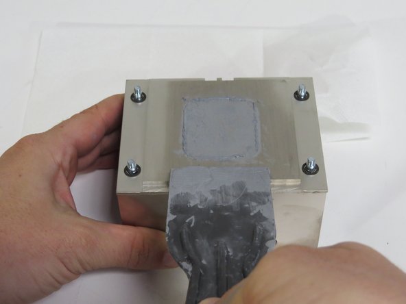 Scrape the thermal compound from the heatsink using a plastic putty knife.