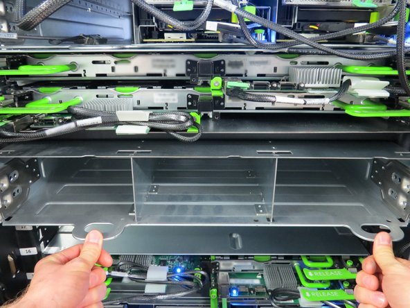 Firmly apply pressure until the metal retention tabs click into place. This indicates that the Cubby sled is secure.