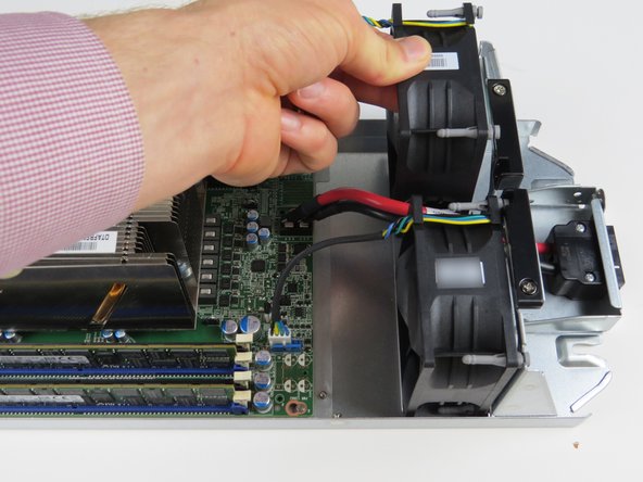 Carefully grab the failed fan and lift upwards to remove from the housing.