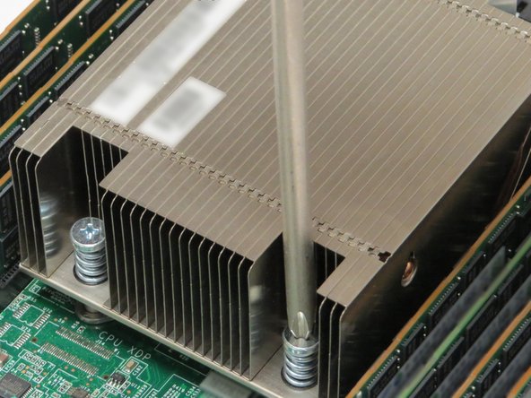 Align two heatsink posts with two holes in the CPU housing bracket, as annotated.