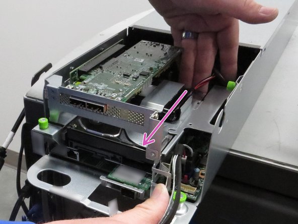 With the retention tab pushed outward, push the HDD towards front of the server.