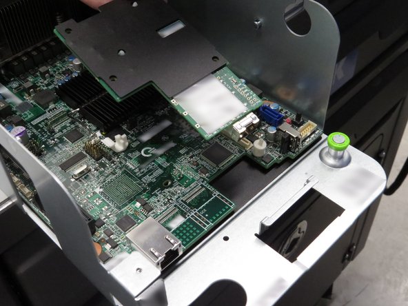 Lift the NIC up and away from the front of the server.