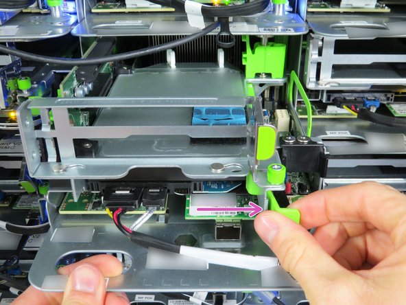 Locate the green retention lever and pull it to the right.