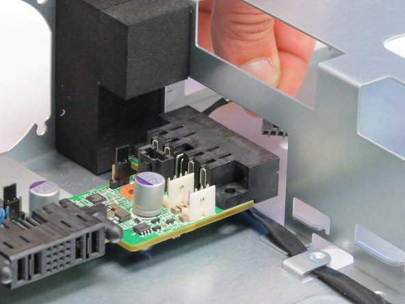 Route the LED cable connector through the chassis cutout near the PSU socket, as shown.