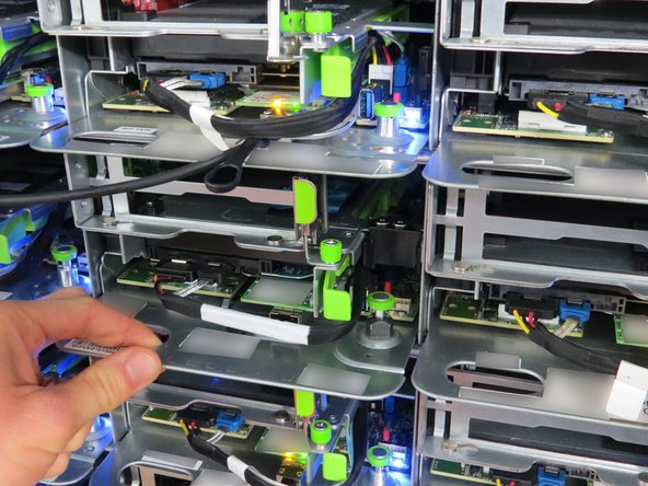 Using the handle, pull the server away from the rack as shown.