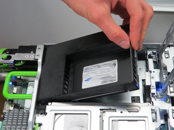 Lower the SSD into the vacant slot.