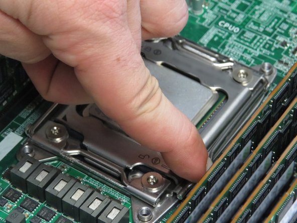 The retention lever is spring loaded. Apply force to the lever as it rises.