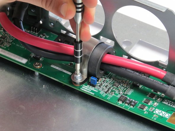 Screw in the Phillips #2 screw to secure the bus lead management clip to the fan controller board.