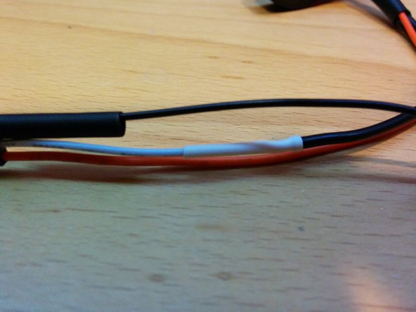 Cut the white wire to length leaving one quarter inch overlap and solder to 1 CT wire. Shrink the tubing.