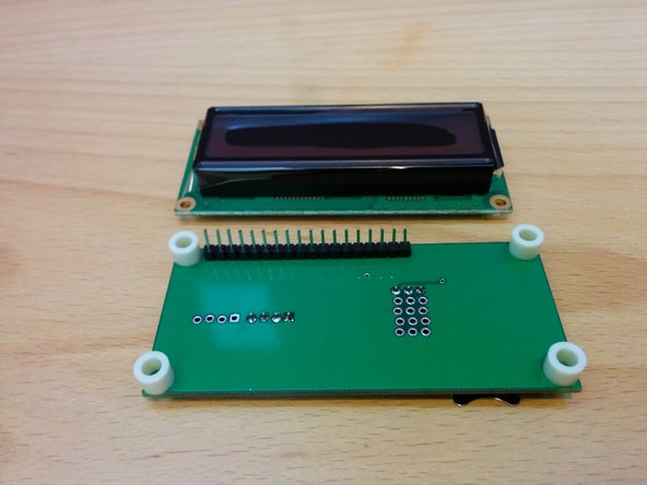Position LCD module on top of the spacers and solder in place.
