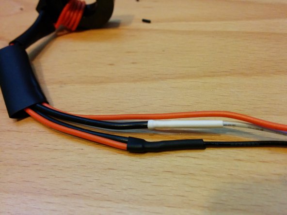 Cut the black wire to length leaving one quarter inch overlap and solder to both the orange wire and the other lead from the CT. Shrink the tubing.