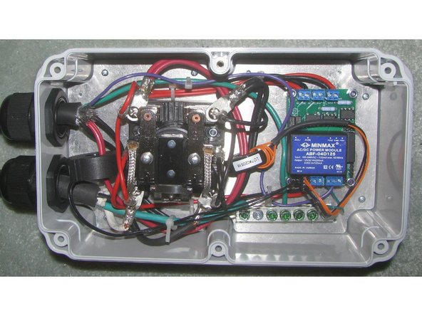 Connect the low-current wires from the input side of the contactor to the AC_LINE inputs on the EFSE board. Connect the low-current wires from the output of the contactor to the AC_TEST inputs. Connect the contactor coil terminals to the DC relay outputs on the EVSE board. Connect the green ground wire from the EVSE board to the ground bar.