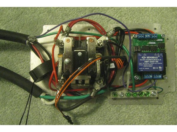 Fit the cable glands to the polycarbonate box. The glands serve both as waterproofing and as strain relief, and should fit snugly around the power cables when tightened.