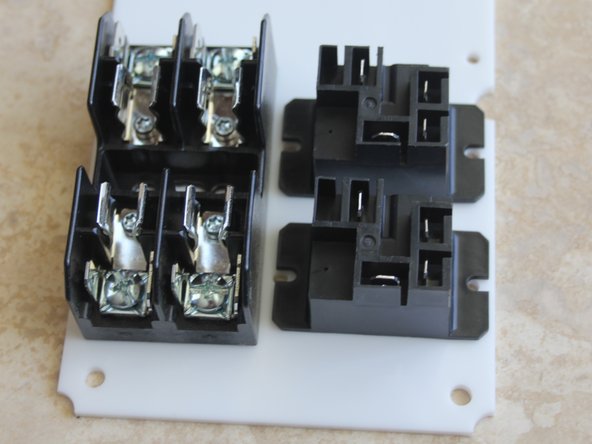 Mount fuse block with 2 - 3/8" screws from the top and lock nuts on the bottom.