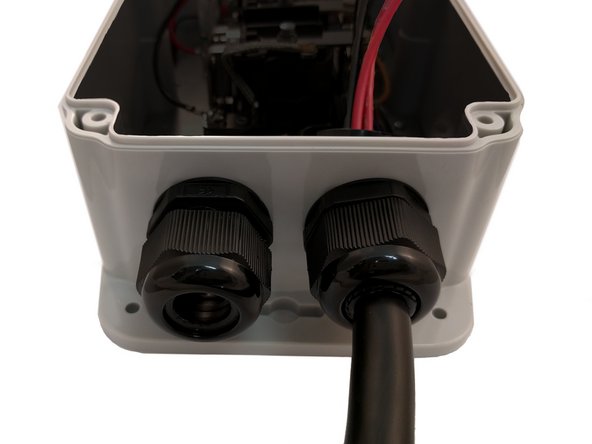 Insert EV Cable through the Cable Gland on the right and tighten.