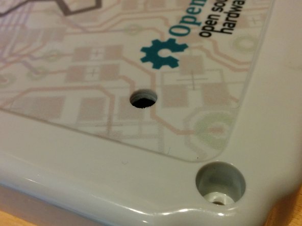 Drill a hole (up to 1/4&quot;) in the bottom left of the enclosure leaving at lease 1/2&quot; inch from the edge of the graphics.