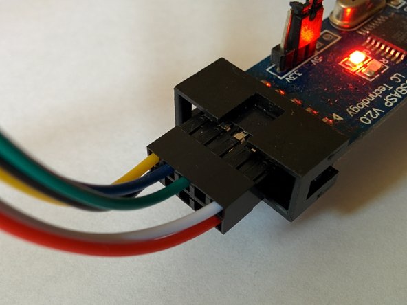 The red stripe on the ribbon cable or yellow wire on the 6 pin connector aligns with pin 1 of the ISP connector.