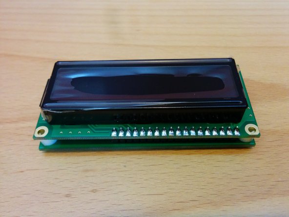 Position LCD module on top of the spacers and solder in place.