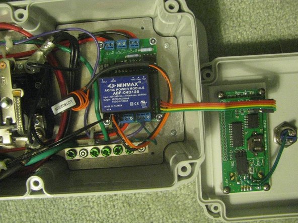 Connect the 4-conductor ribbon cable from the LCD board on the lid to the 4-pin header on the EVSE board. The green (ground) wire connects to the pin with the square solder pad next to the screw. Use the 4-pin header at the edge of the board, not the 6-pin header next to it.